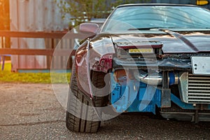 Closeup of a drift car. Seriously prepared and tuned sports car. LED headlights, radiator, bumper removed. Established negative