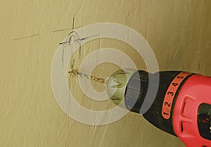 Closeup of drill machine. Drilling hole in the wall.