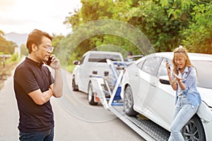 Closeup driver in Car Accident using mobile phone with damaged car truck slides on countryside