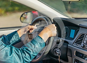 Closeup of a driver hands on steering wheel. Woman`s hands holding steering wheel