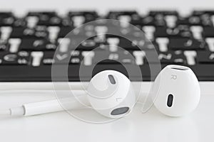 Closeup earbuds music accessories on laptop computer