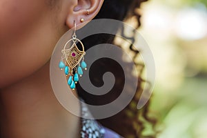 closeup of ears with bohostyle turquoise earrings photo