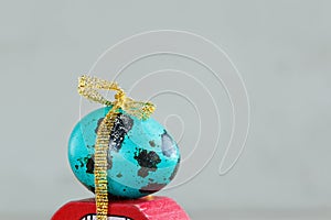 Closeup Easter blue egg on red car. Holiday easter concept.