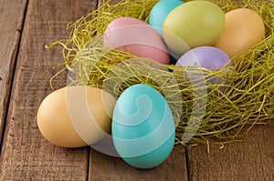 Closeup of Easter Eggs in Nest on Wood