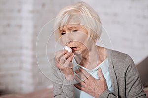 Closeup of elderly coughing woman