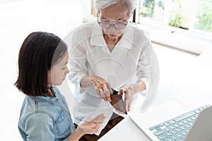 Closeup elderly woman hands open wallet,grandmother or guardian giving pocket money to granddaughter,asian little girl demanding