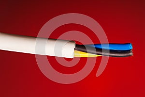 closeup of a electric cable on a red background.