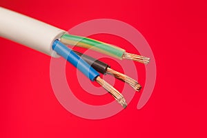 closeup of a electric cable on a red background