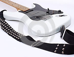 Closeup.electric guitar with metal strap. on white.