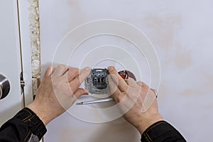 Closeup of electrician hands installing wall socket