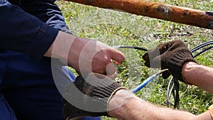 Closeup of electrician hands, tools and wires. insulation of electrical wire. slow motion