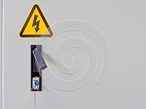 Closeup of electrocution hazard icon sticker on power panel door