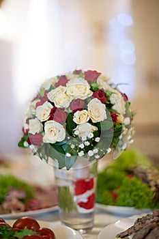 Closeup of elegant freshly cut wedding bouquet with white and re