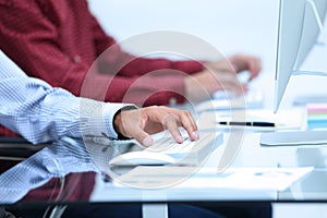 Closeup of employees typing on the keyboard