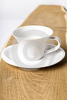 Closeup of an empty cup of coffee and a plate