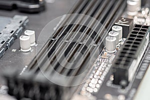 Closeup on empty RAM slots on a modern black silver motherboard. Random access memory stick slots. Macro of electronics and