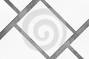 Closeup of empty white rectangle poster mockups lying diagonally on grey concrete background photo