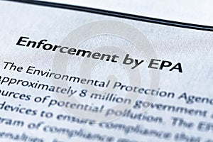 Closeup of the Enforcement by EPA or Environmental Protection Agency of the Government, printed in textbook on white page.