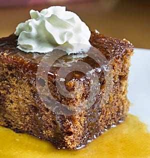 Closeup of english toffee pudding topped with vanilla whipped cream