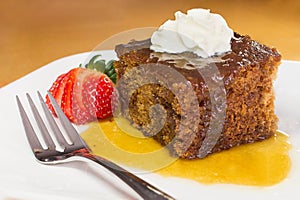 Closeup of english toffee pudding topped with vanilla whipped cream photo