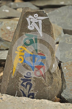 Closeup of engraved stone with Buddhist mantra Om Mani Padme Hum in Zanskar Valley, Ladakh, INDIA