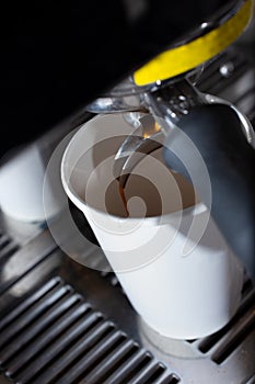 closeup espresso machine brewing coffee paper cup pour