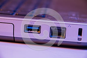 Closeup of Ethernet cable and USB ports in a laptop photo