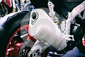 Closeup of exhaust or intake of racing motorcycle. Low angle photograph of motorcycle.