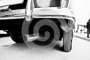 Closeup exhaust pipe of old vintage car. Black and white photo