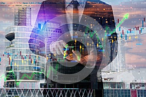 Closeup exposure of couple of businessmen using tablets with cityscape and financial graphs on building background
