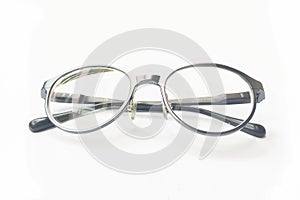 Closeup on Eyeglasses with bright light on white paper background.