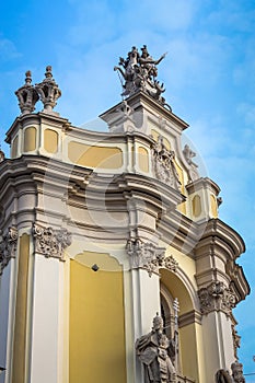 closeup facade of church of St. Jura with different large sculptures against blue sky