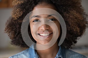 Closeup face African teen lady look at camera with smile