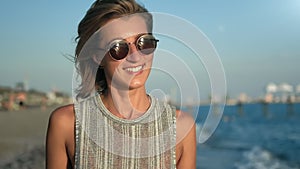 Closeup face of attractive tourist woman laughing relaxed at seascape background slowmo