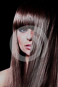 Closeup face of beautiful woman with long black curly hairs.