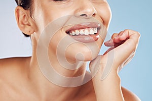Closeup face beautiful young mixed race woman. Attractive female smiling in studio isolated against a blue background