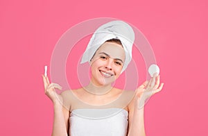 Closeup face of beautiful young smiling woman with bath towel on head. Beautiful woman face isolated on studio. Natural