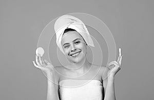 Closeup face of beautiful young smiling woman with bath towel on head. Beautiful woman face isolated on studio. Natural