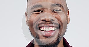 Closeup, face and a black man on a white background, laughing and showing confidence. Smile, young and portrait of an