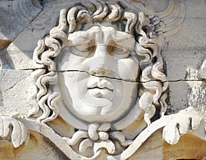 Closeup of a face carved on marble in classical style by ancient Greeks at the Temple of Apollo in Didyma. An impressive