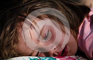 Closeup face of kid lying in bed and sleeping. Child sleep quietly calmly on bed at home. Adorable cute toddler or baby