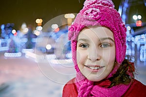 Closeup face of little girl in winter knitted hat photo