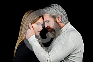 Closeup face portrait of sensual couple. Young sexy couple in each other's arms on a black background.