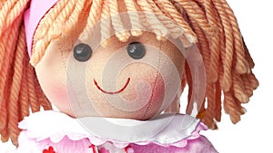 Closeup face rag doll smiling on a white background