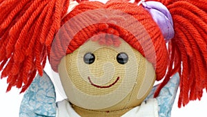 Closeup face rag doll smiling on a white background rotating