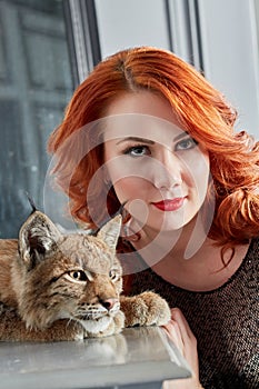 Closeup face of red-haired young woman and muzzle photo
