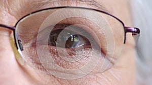 Closeup face of a senior womans eye with glasses to improve her vision. Portrait of an elderly lady with spectacles to