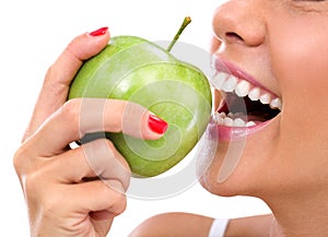 Closeup of the face of a woman eating a green apple