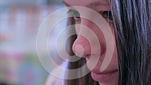 Closeup face of young girl with moving eyes reading something.