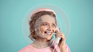 Closeup face of young woman pretty surprised pinup girl talking on cell phone. Retro vintage pinup style. Call center